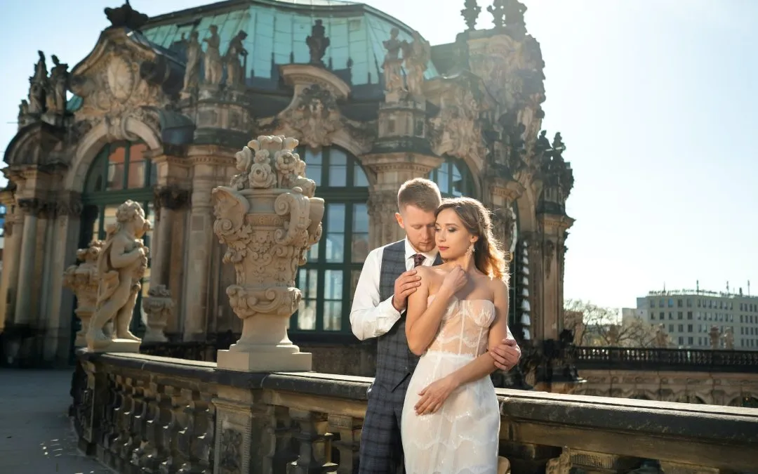 A couple in love on a wedding walk at the famous Baroque Zwinger Palace in Dresden, Saxony, Germany