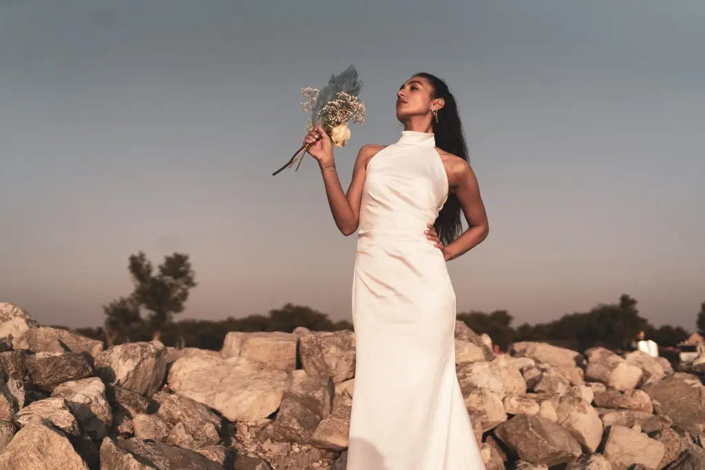 Bride with bridal bouquet standing on rocks