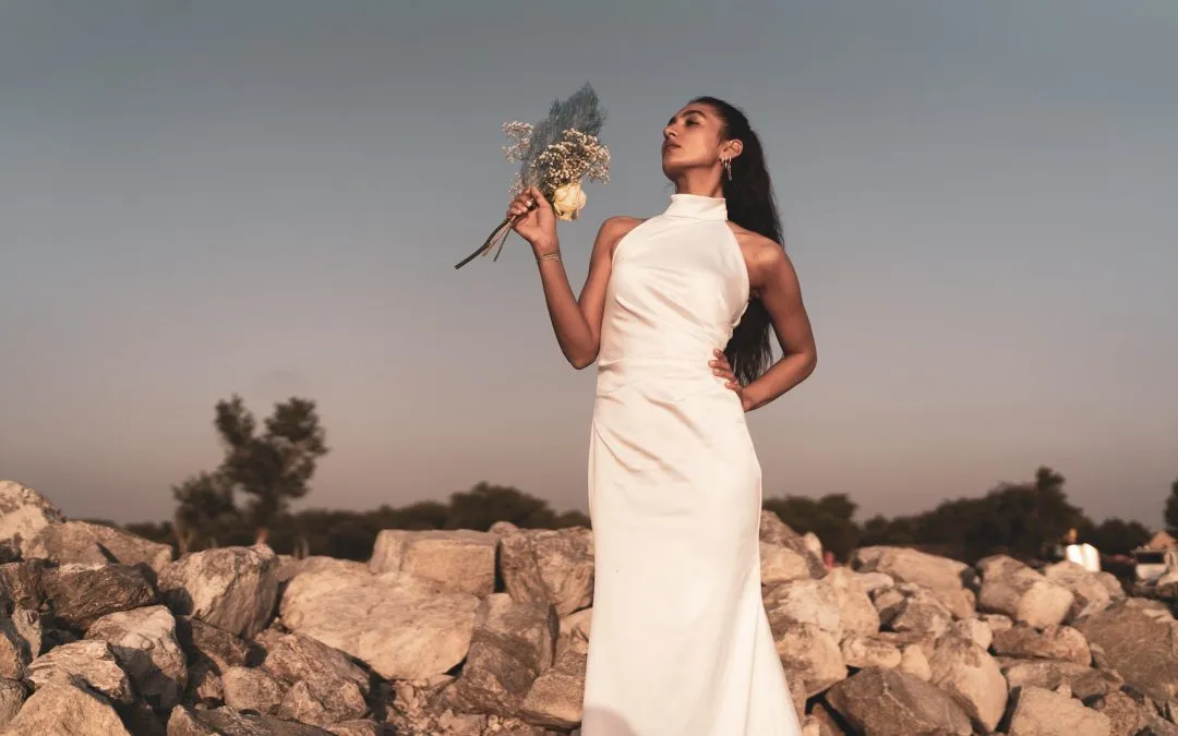 Bride with bridal bouquet standing on rocks
