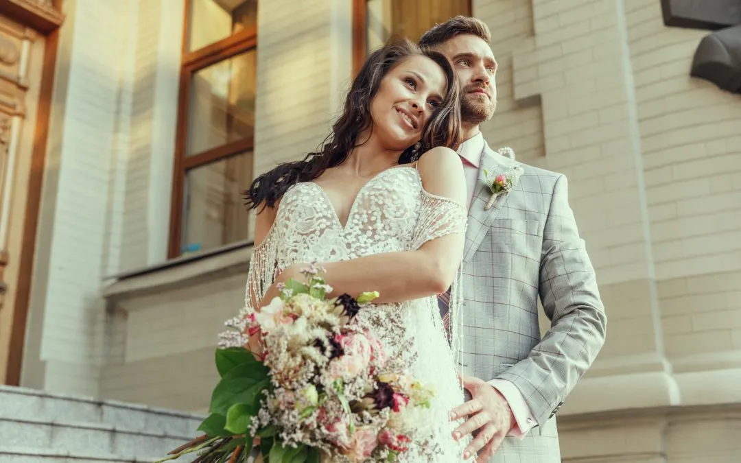 Caucasian romantic young couple celebrating their marriage in city