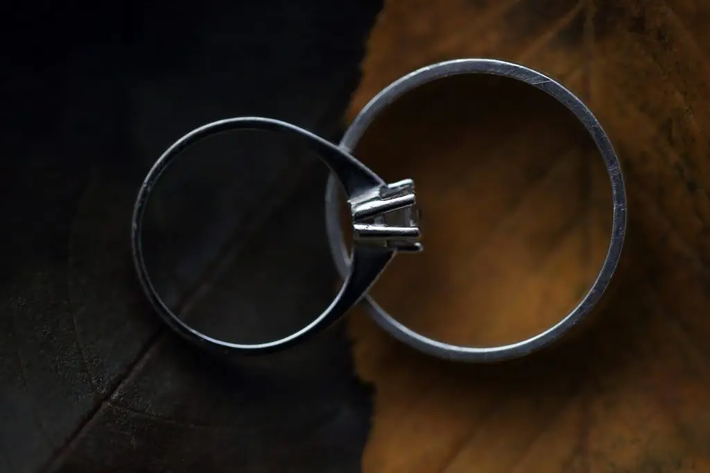 Macro shot of wedding ring on yellow leaf