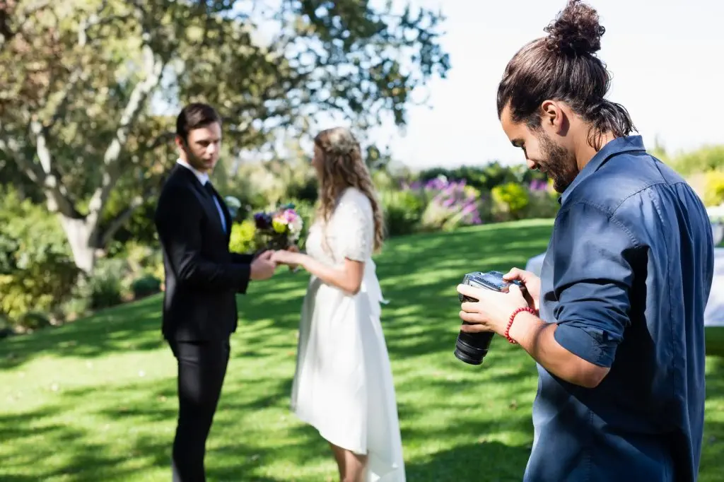 Photographer reviewing photographs on digital camera