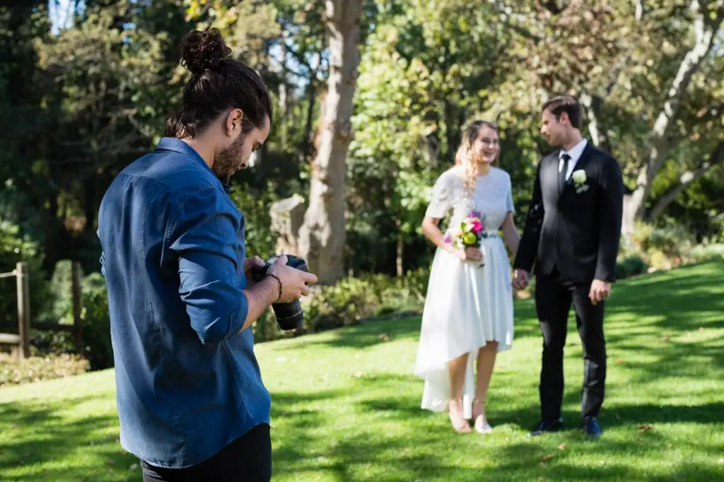 Photographer reviewing photographs on digital camera