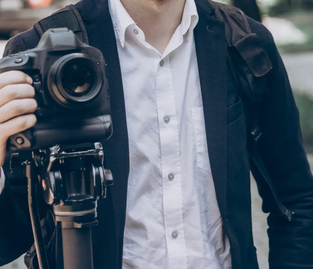 stylish man holding photo camera