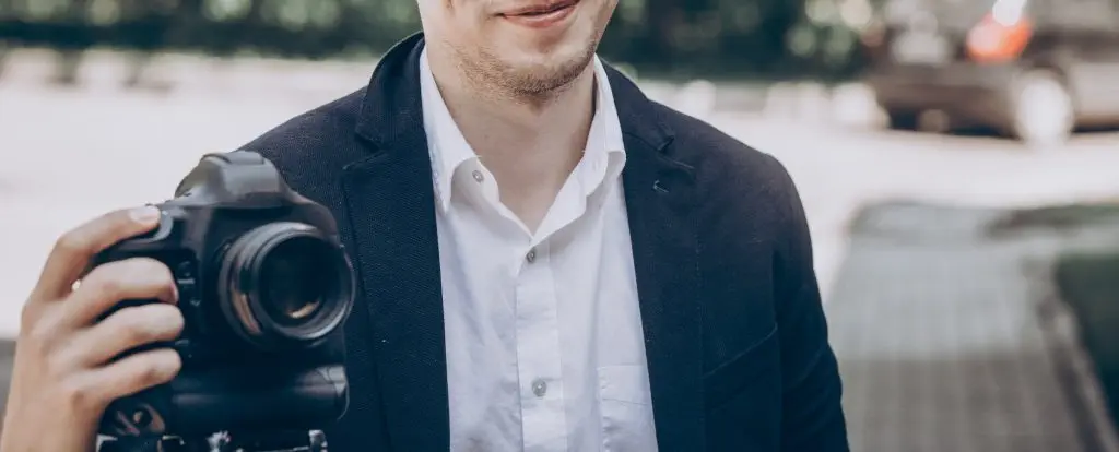 stylish man holding photo camera