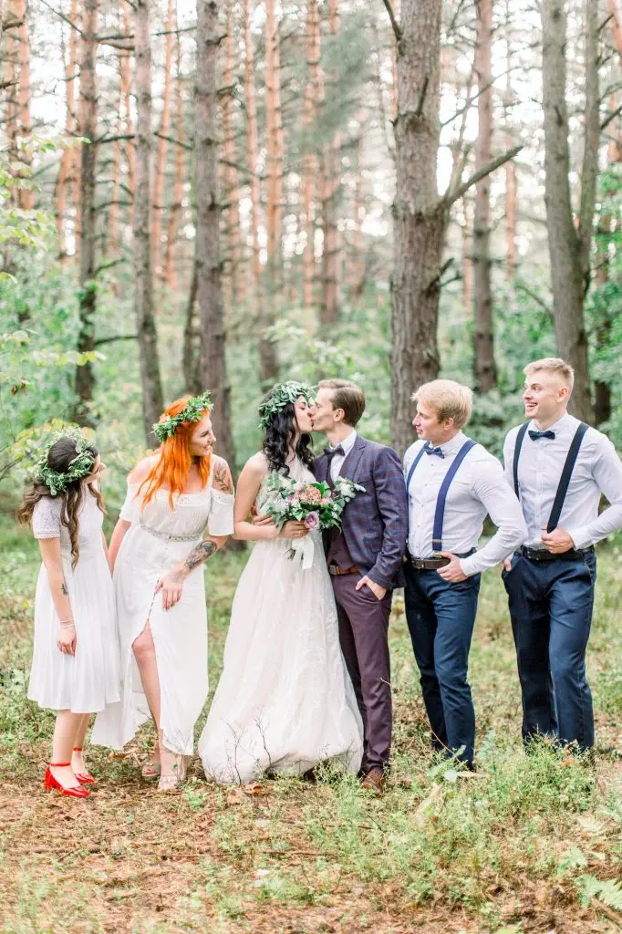The group photo of the groom and his best men, the bride with the bridemaids at the background of