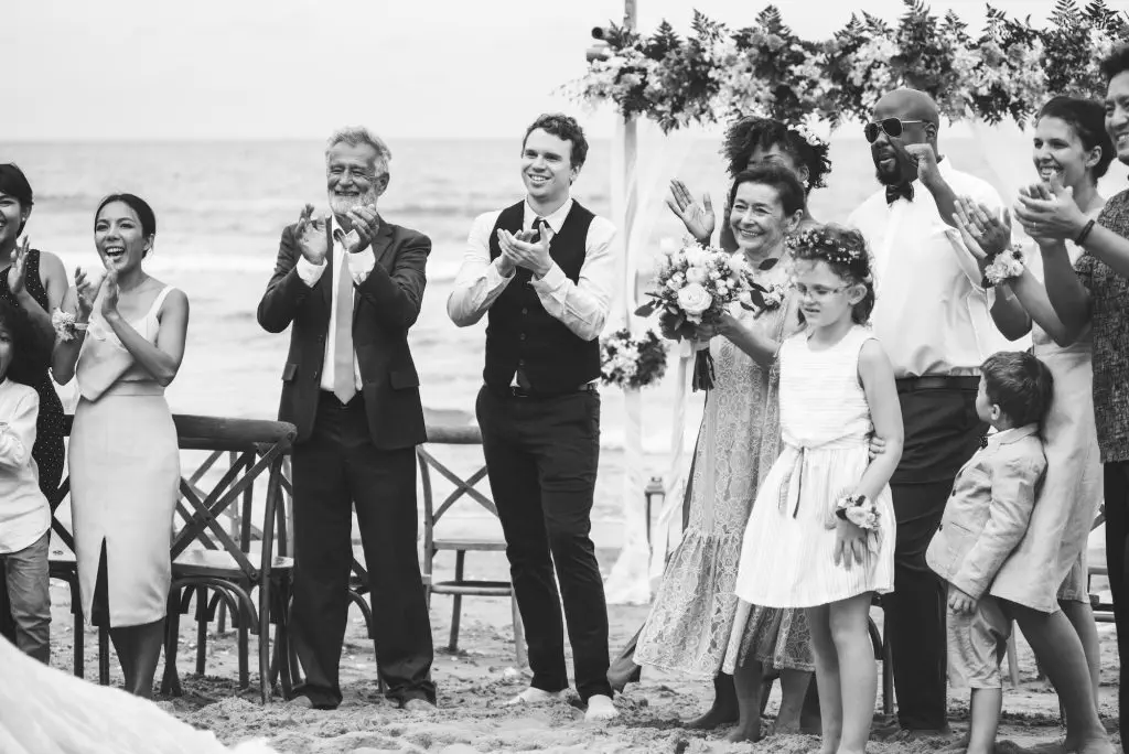 Wedding guests clapping for the bride and groom