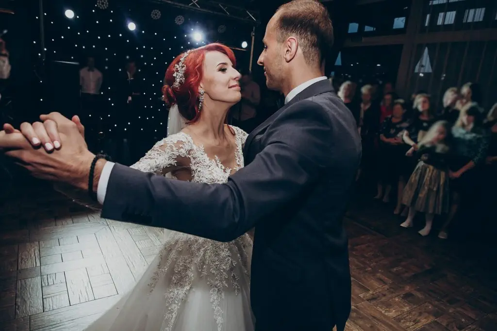 Gorgeous wedding couple performing first dance in restaurant