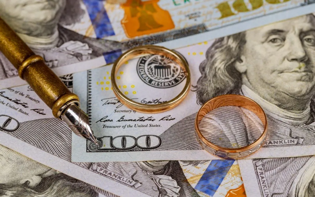 Marriage contract of convenience, golden wedding ring on pen on dollar banknotes background