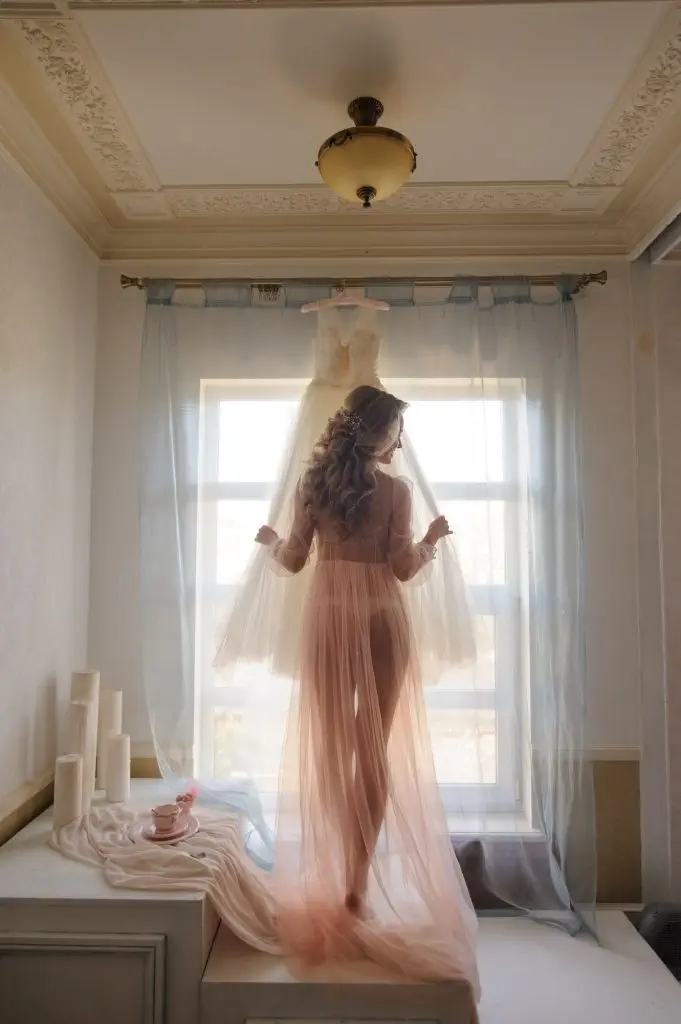 Morning of a beautiful young bride in a boudoir dress.