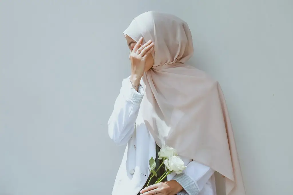 Muslim Woman with Scarf Covering Her Face with Hand