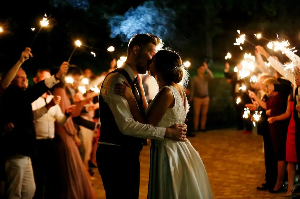 wedding, kiss, evening, sparklers lit the guests around the young